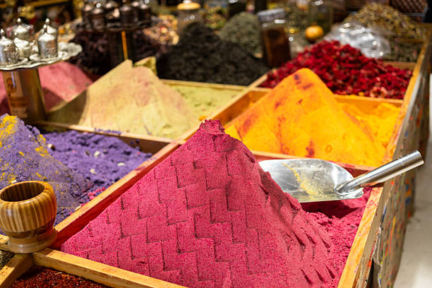Colorful spices arranged in wooden containers at a vibrant market showcasing rich textures and hues
