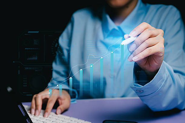 Business growth. Professional data analyst using digital tools to visualize growth trends and metrics from a laptop on a modern workspace Business growth. Professional data analyst using digital tools to visualize growth trends and metrics from a laptop on a modern workspace. visualize growth stock pictures, royalty-free photos & images