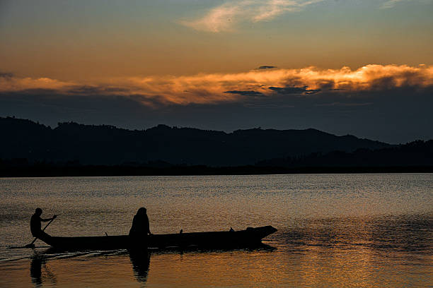 istock Silhouetted Fishermen on Lake Mutanda at Sunset 2223096323