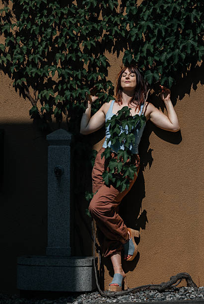 istock Young caucasian female posing in sunlight with leafy background 2223097715