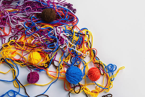 Colorful tangled threads and  winding them into balls. Concept of problem solution. Copy space