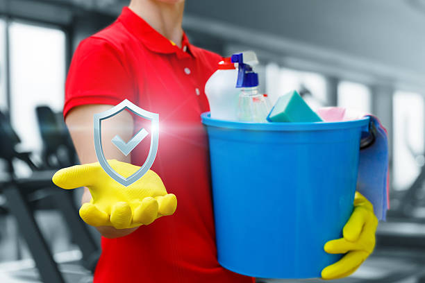 A cleaning professional showcases a commitment to high-quality cleaning standards while holding a bucket of supplies.