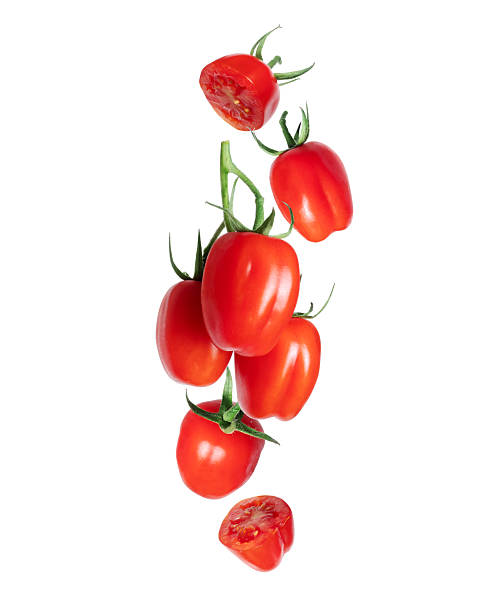 wet red cherry tomatoes in plastic basket on wooden background