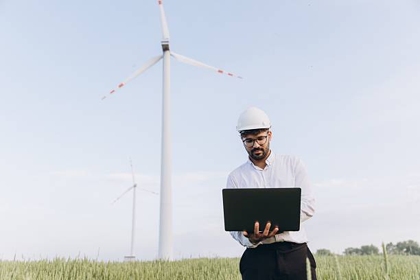 istock Arabian engineer working with laptop in a wind turbine power plant 2223099717
