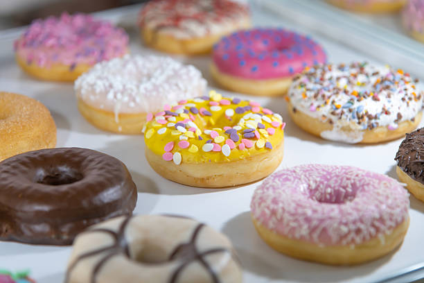 istock Colorful assortment of donuts displayed for customers in a bakery 2223102164