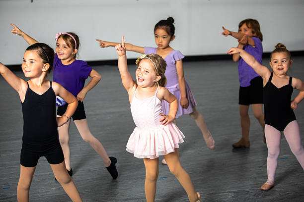 istock Elementary aged children practicing ballet and theatre combo class in a dance studio 2223102197