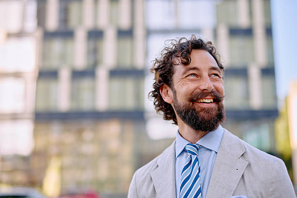 istock Smiling Businessman Looking Up in a Modern City 2223103392