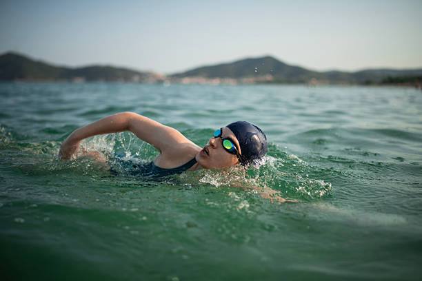 istock Determined woman swimming in sea. 2223106844