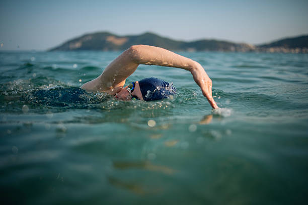 istock Determined woman swimming in sea. 2223106845