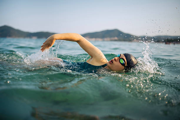 Determined woman swimming in sea.
