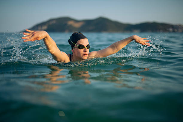 istock Determined woman swimming in sea. 2223106852
