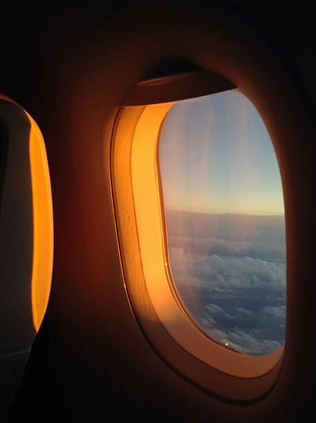 istock Golden light softly reflects on the airplane window 2223108412