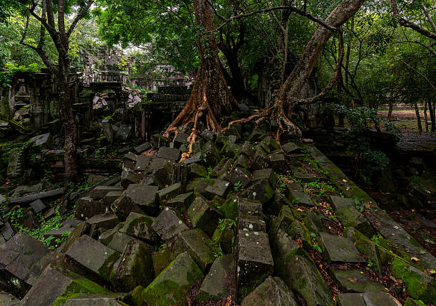 A column of pebbles among the ancient ruins. Сolumn of stones.