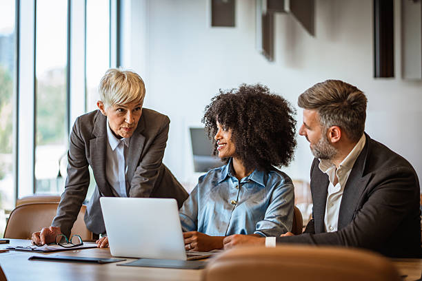 istock Helpful female boss mentor explain new project to diverse employers 2223109388