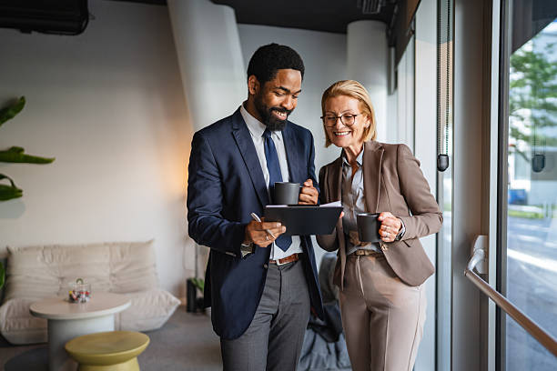 istock multicultural man and woman colleague work together tech for research 2223109820