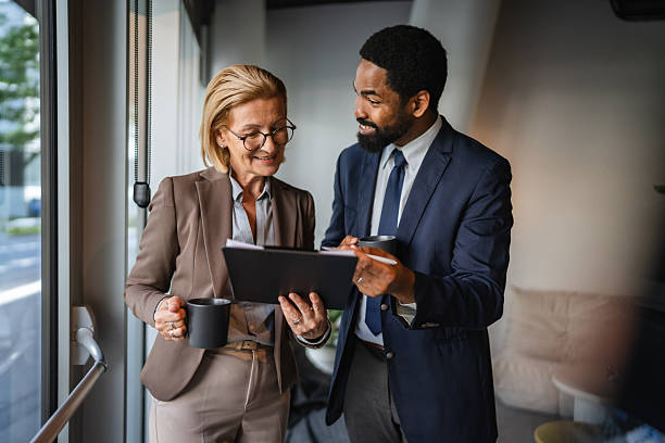istock multicultural man and woman colleague work together tech for research 2223110230
