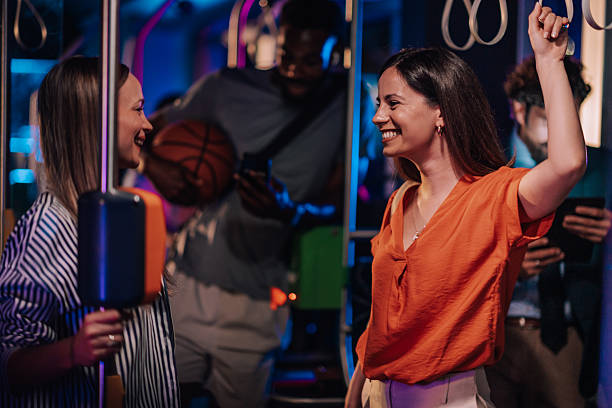 istock Young women talking and having fun on a moving bus at night 2223114195