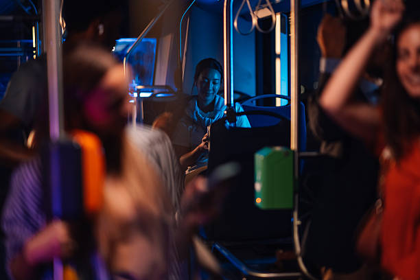 istock Young woman using smartphone on night bus ride home 2223114201