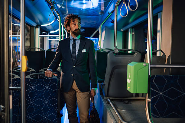 istock Businessman standing on a modern bus at night 2223114271
