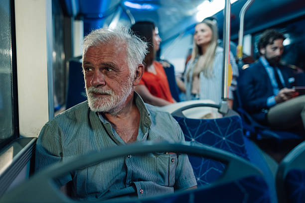 istock Senior man sitting on bus looking out window during commute 2223114300
