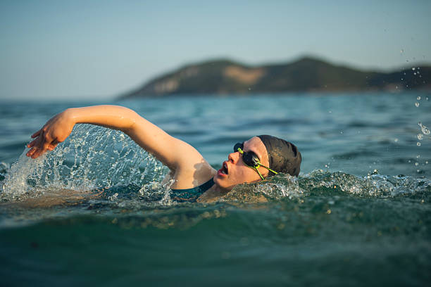 istock Female swimmer swimming forward crawl in sea. 2223114446