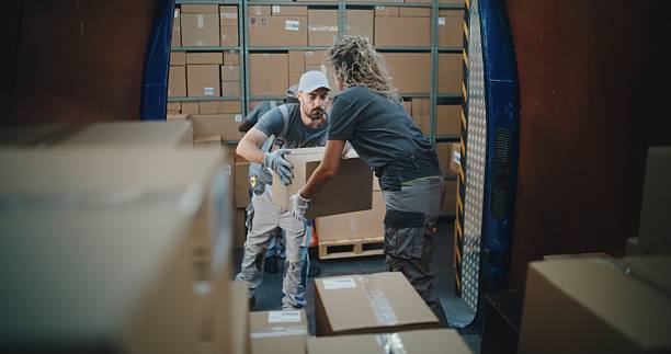 istock Multiethnic Workers Unloading Cardboard Boxes with Online Orders from Delivery Truck 2223116230