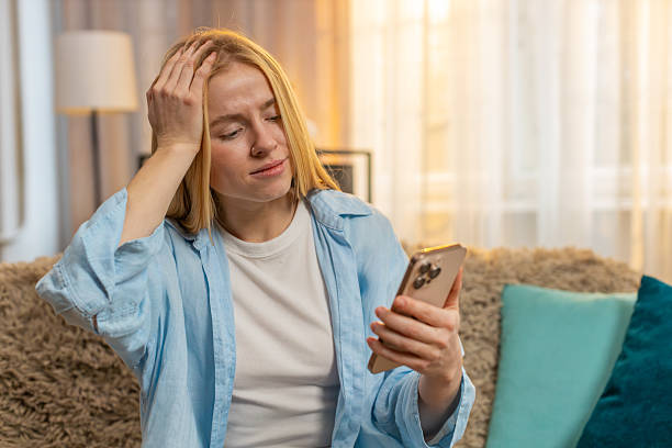 istock Young woman upset by phone fail, negative message, sudden meltdown, home sadness, deep frustration 2223121022