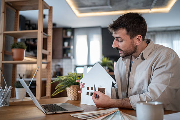istock Architect designing house renovation project using color swatches and a model 2223122535
