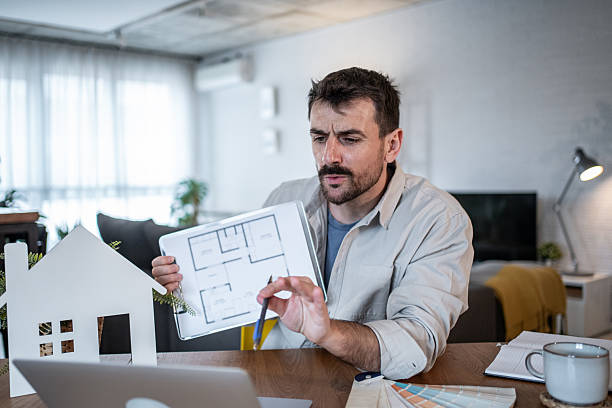 istock Architect showing house plan during video call at home office 2223122797