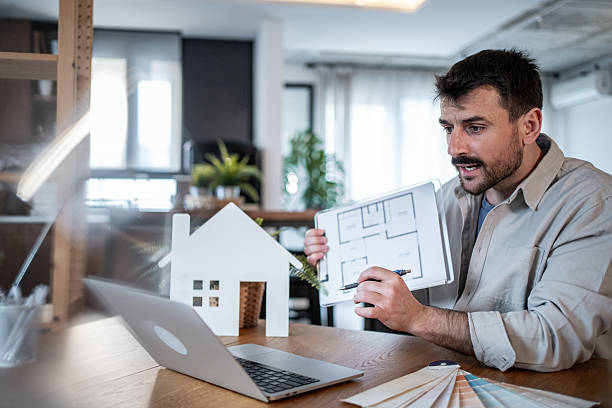 istock Architect showing house plan during video conference call 2223122846