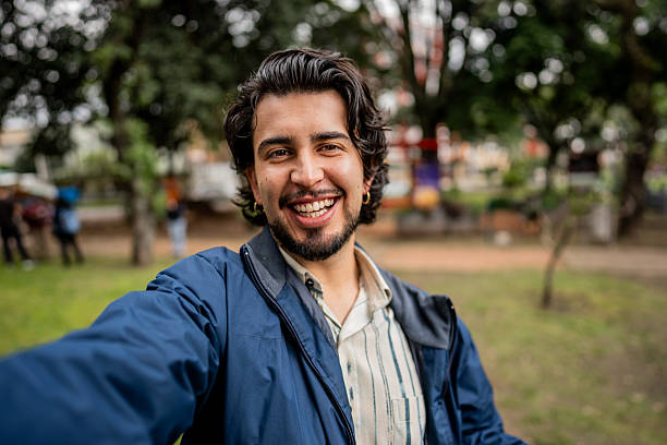 istock Young man taking a selfie in the town square - camera point of view 2223123202