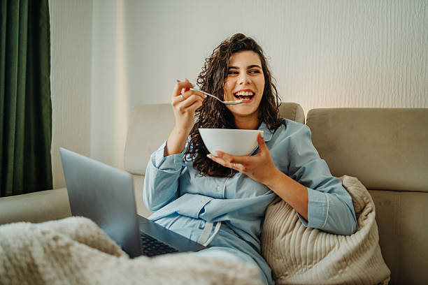 istock Young caucasian woman eating cereals for breakfast 2223126420