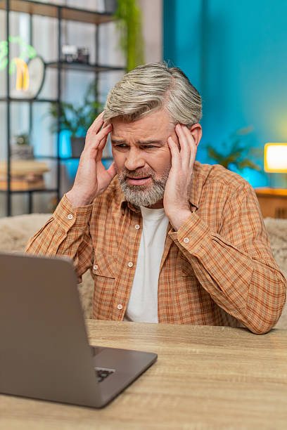 istock Mature man sitting at table closing laptop, showing defeat after losing game or fail project at home 2223128331