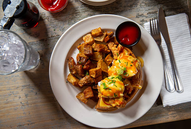Eggs Benedict over warm waffles and home fries