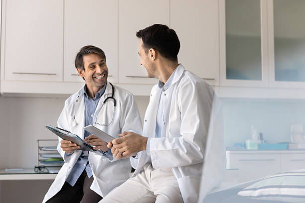 istock Happy successful middle aged doctor men holding tablet 2223137836