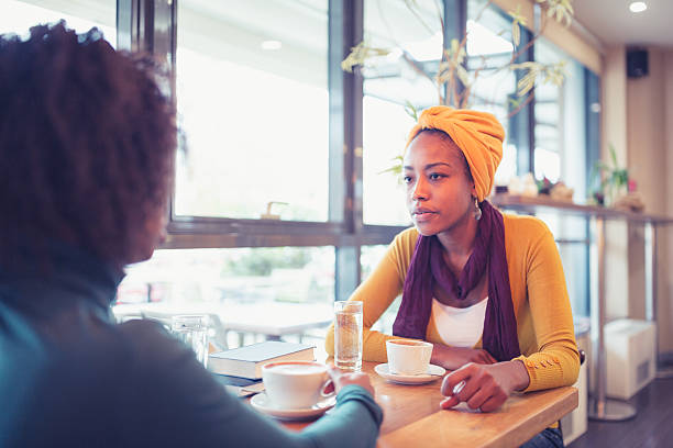 istock Two Women Chatting Over Coffee in Bright Cafe 2223138881