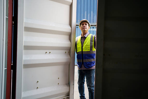 istock Customs clearance officer or shipyard engineer is inspects against the import - export cargo containers. 2223139820