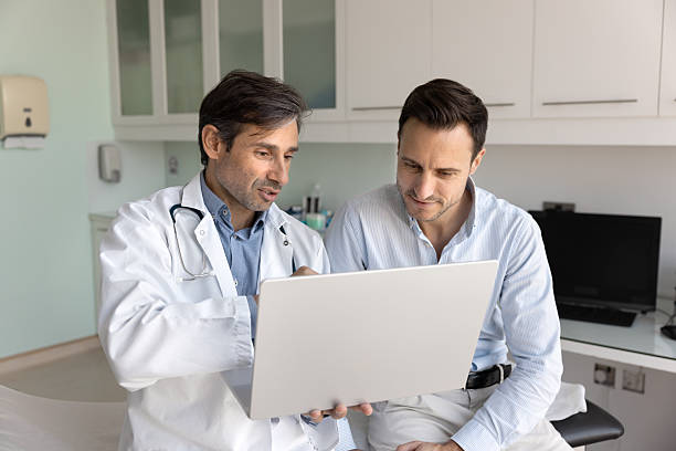 istock Focused doctor and patient reading examination report together 2223141209