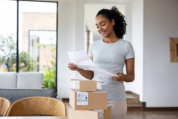 istock Woman receiving a letter in the mail and smiling while reading it 2223141307