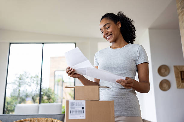 istock Happy woman at home checking her mail 2223141314