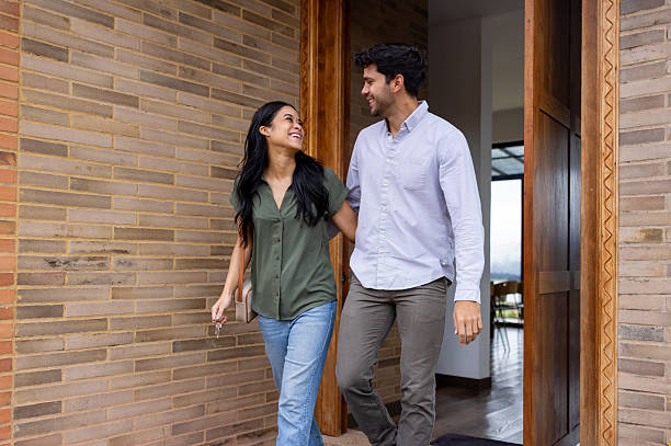 istock Happy couple leaving their house and smiling 2223141364