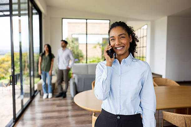 istock Real estate agent taking a call while showing a house to a couple 2223141376