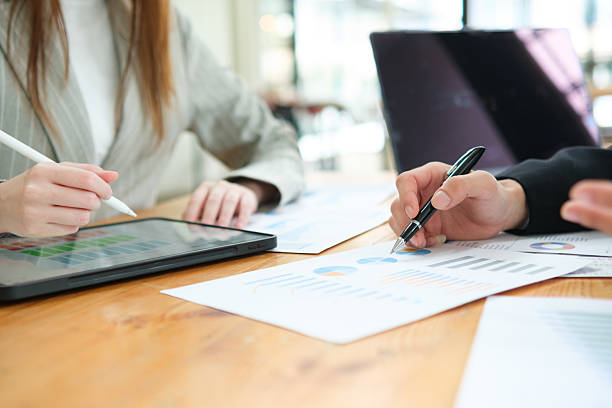istock Two business people discuss and analyse financial strategy colleagues. 2223142433