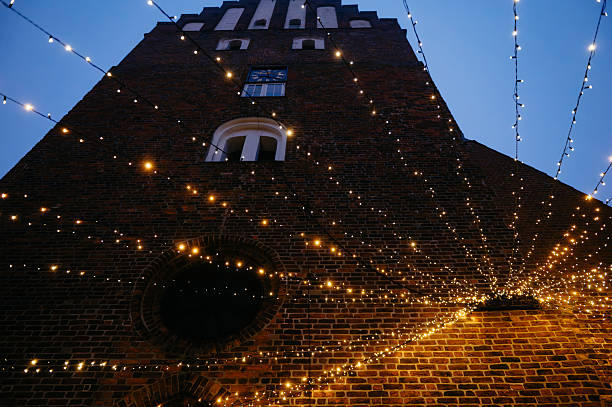 istock String Lights Hanging in Front of Historic Brick Tower at Dusk 2223142897