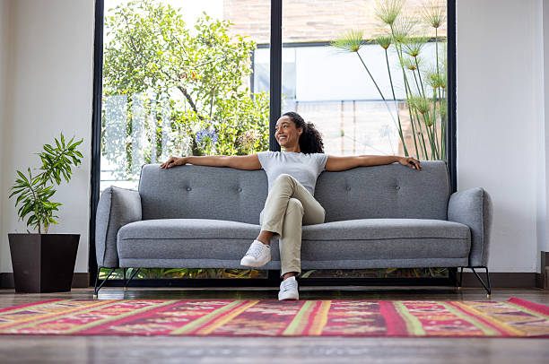 istock Happy woman relaxing on the sofa at home 2223144232