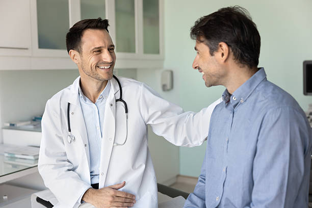 istock Cheerful supportive empathetic doctor man touching shoulder of patient 2223147568