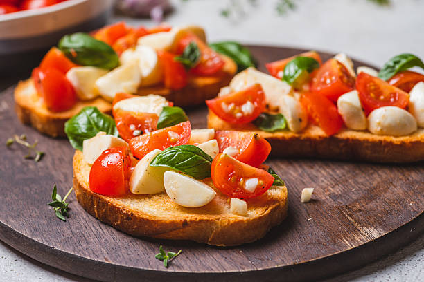 istock Bruschetta caprese with cherry tomatoes and mozzarella garnished with basil 2223149640