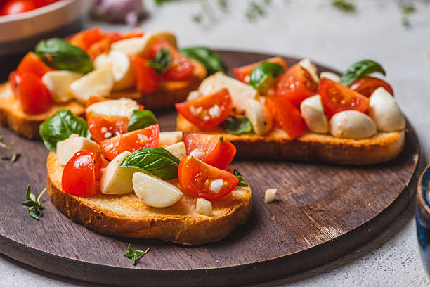 istock Bruschetta caprese with cherry tomatoes and mozzarella garnished with basil 2223149642