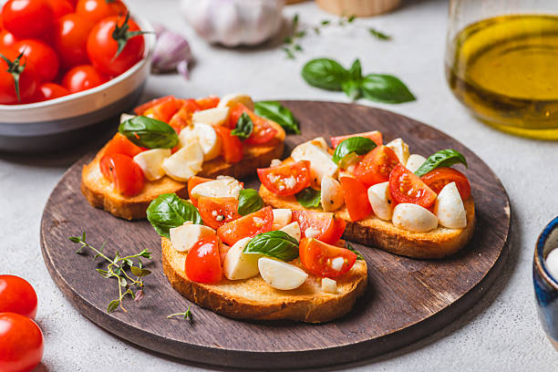 istock Bruschetta caprese with cherry tomatoes and mozzarella garnished with basil 2223149662