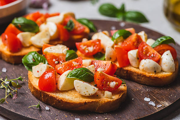 istock Bruschetta caprese with cherry tomatoes and mozzarella garnished with basil 2223149667
